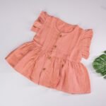 Peach Muslin Baby Frock with Wooden Buttons – Soft & Stylish