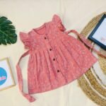 Pink Dino Muslin Baby Frock with Wooden Buttons – Soft & Stylish